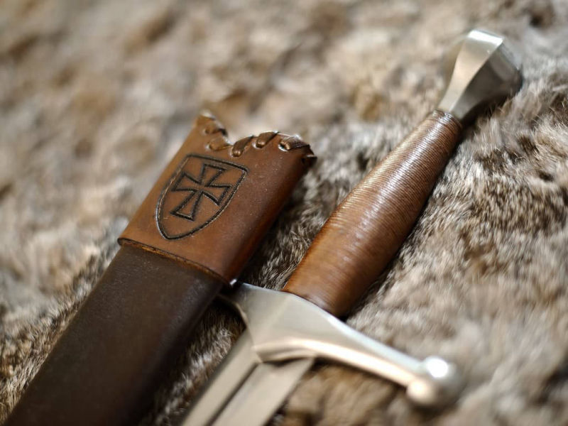 Dague médiévale allemande posée sur une peau naturelle